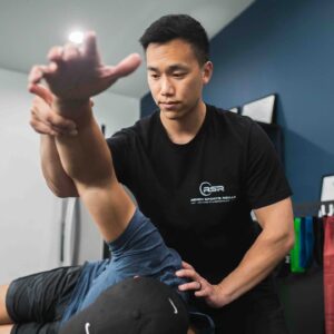 Patient working with a provider at a performance physical therapy clinic in Torrance during a comprehensive movement evaluation